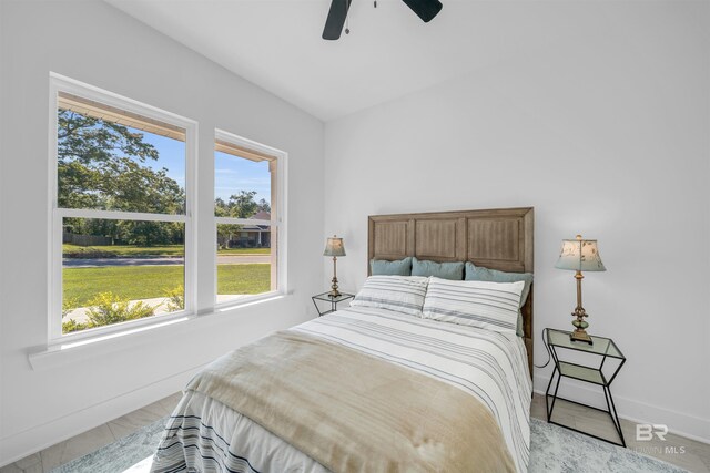 7056 Stone Chase Ln, Gulf Shores, AL 36542 - bedroom featuring ceiling fan, baseboards, and multiple windows