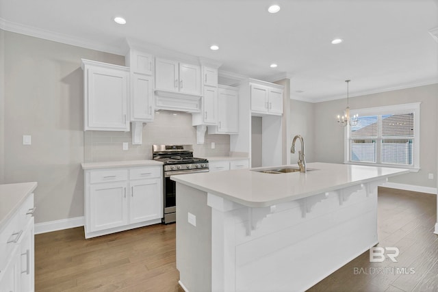 10606 Secretariat Blvd, Daphne, AL 36526 - kitchen with stainless steel range with gas stovetop, wood finished floors, crown molding, and a sink