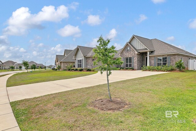 10606 Secretariat Blvd, Daphne, AL 36526 - craftsman-style house with brick siding, board and batten siding, a residential view, and a front yard