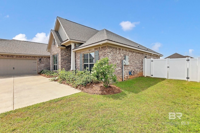 10606 Secretariat Blvd, Daphne, AL 36526 - view of home's exterior featuring a gate, a lawn, brick siding, concrete driveway, and an attached garage