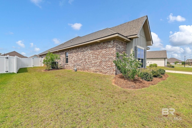 10606 Secretariat Blvd, Daphne, AL 36526 - view of side of property with a garage, a yard, a gate, brick siding, and fence