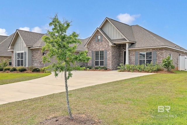 10606 Secretariat Blvd, Daphne, AL 36526 - craftsman inspired home featuring a front yard, roof with shingles, board and batten siding, and brick siding
