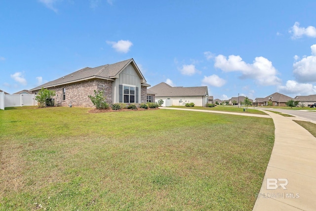 10606 Secretariat Blvd, Daphne, AL 36526 - view of property exterior with a residential view, a lawn, board and batten siding, brick siding, and fence