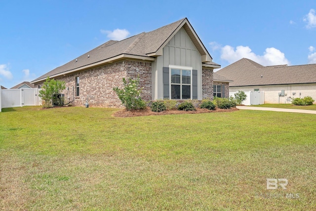 10606 Secretariat Blvd, Daphne, AL 36526 - view of property exterior with a gate, a lawn, board and batten siding, brick siding, and fence