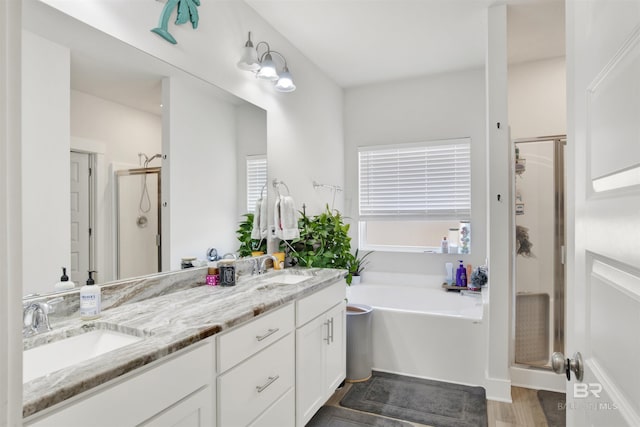 bathroom featuring vanity, shower with separate bathtub, and hardwood / wood-style floors