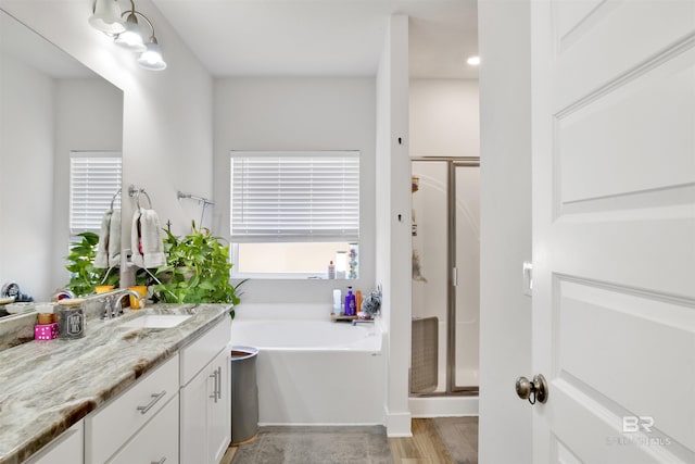 bathroom with vanity, plus walk in shower, and hardwood / wood-style floors