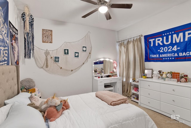 bedroom featuring light carpet and ceiling fan