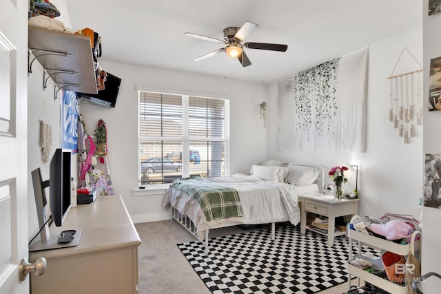 bedroom featuring light carpet and ceiling fan