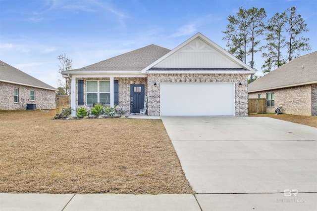 view of front of home with a garage and central AC