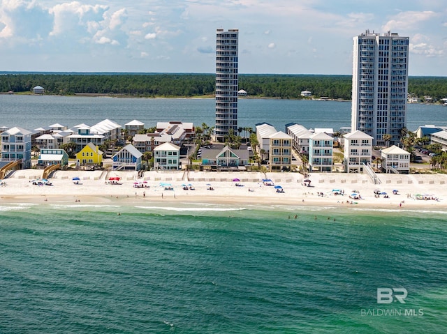 drone / aerial view featuring a water view and a view of the beach