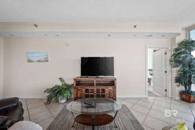 tiled living room with a textured ceiling