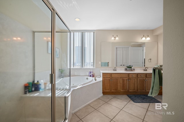 bathroom featuring tile patterned floors, vanity, and shower with separate bathtub