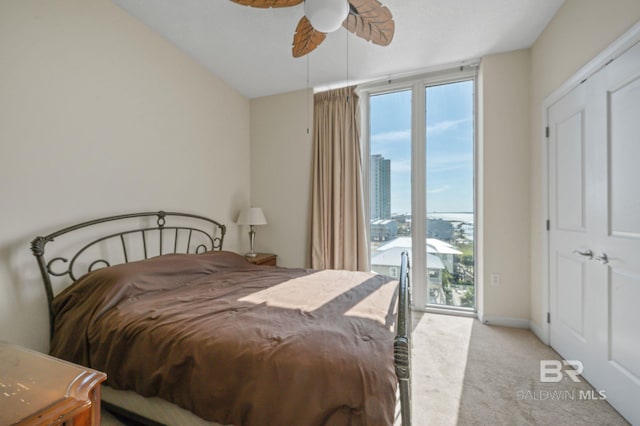 carpeted bedroom featuring ceiling fan and access to outside