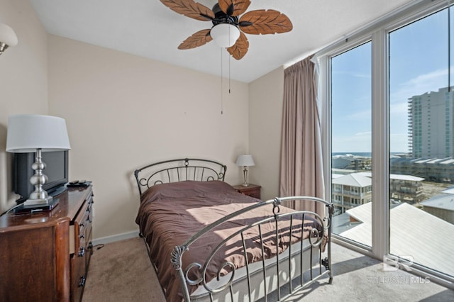 carpeted bedroom featuring access to outside and ceiling fan