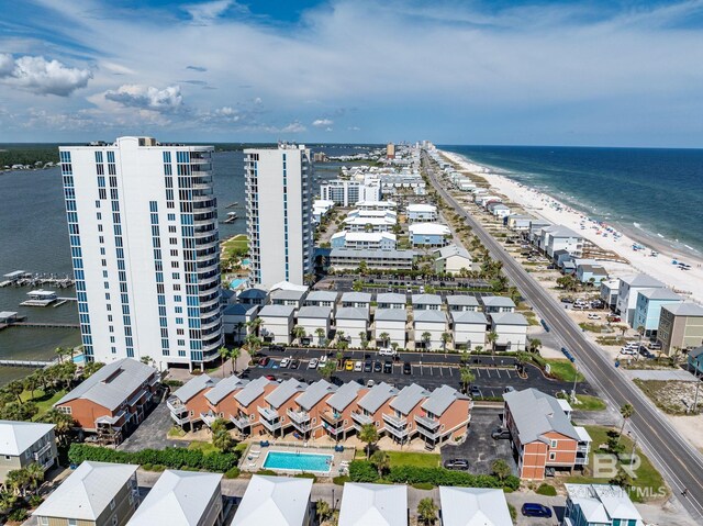 drone / aerial view with a beach view and a water view