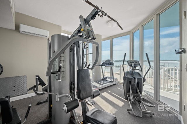 gym with a wall of windows, a wall mounted AC, and a water view