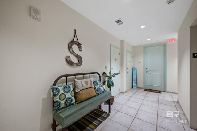 hall featuring light tile patterned floors