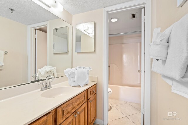 24230 Perdido Beach Blvd Unit 3014, Orange Beach, AL 36561 - bathroom featuring toilet, vanity, a textured ceiling, tile patterned flooring, and  shower combination