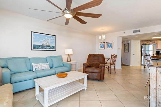 24230 Perdido Beach Blvd Unit 3014, Orange Beach, AL 36561 - living area with light tile patterned floors, a ceiling fan, a chandelier, baseboards, and a textured ceiling
