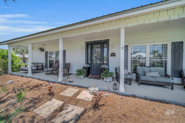 view of exterior entry with covered porch