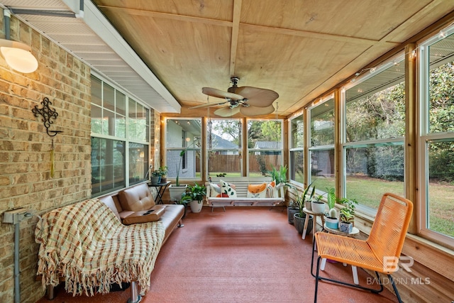 sunroom featuring ceiling fan and a healthy amount of sunlight