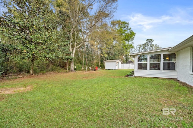 view of yard with a sunroom and a shed