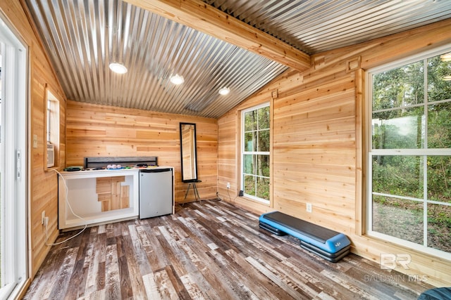 interior space featuring wood walls, wood-type flooring, and lofted ceiling