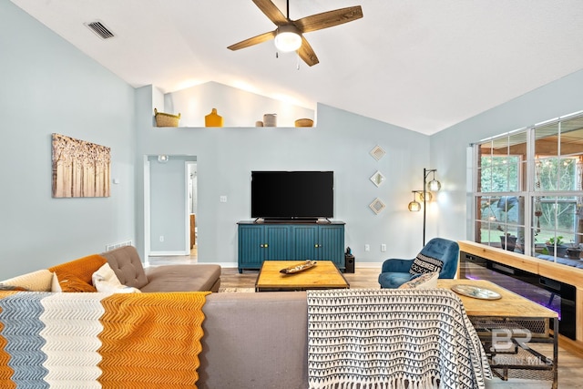 living room featuring hardwood / wood-style flooring, vaulted ceiling, and ceiling fan