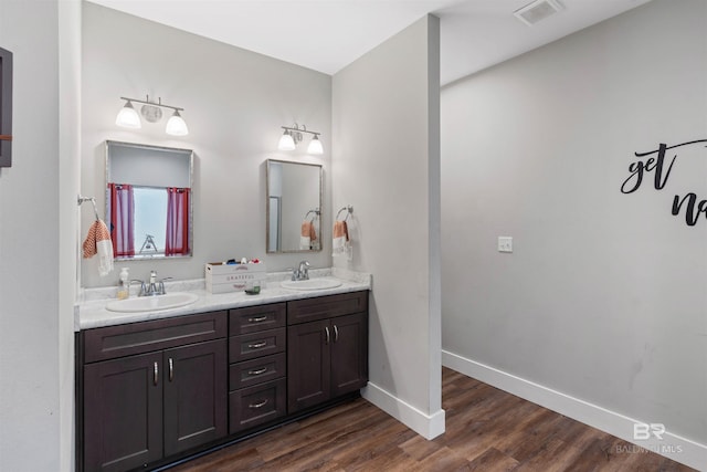 bathroom with vanity and wood-type flooring