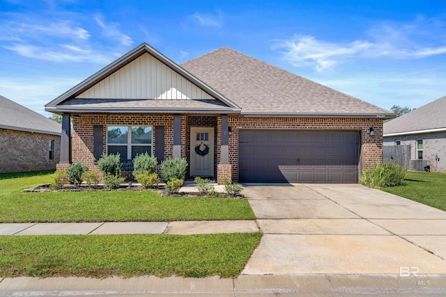 view of front of home with a front lawn and a garage