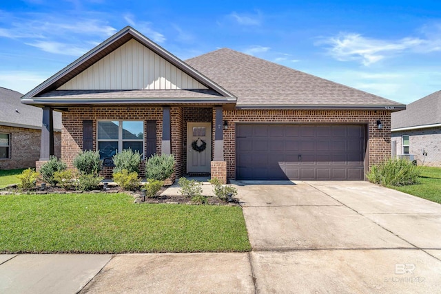 9439 Eiland Dr, Foley, AL 36535 - view of front facade featuring brick siding, board and batten siding, an attached garage, driveway, and a front yard