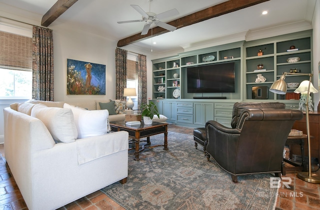 living room featuring ceiling fan, crown molding, and beam ceiling