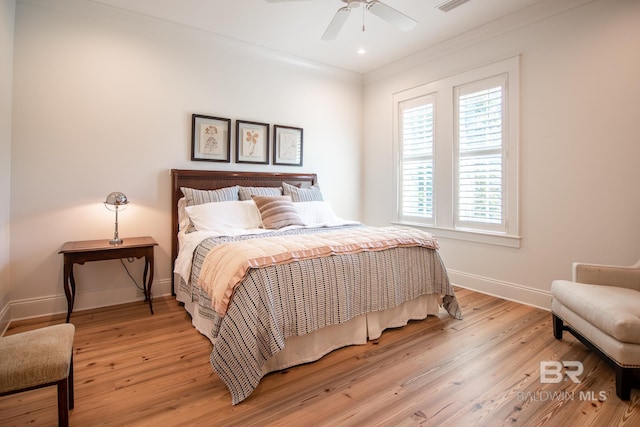 bedroom with ceiling fan, light hardwood / wood-style flooring, and crown molding