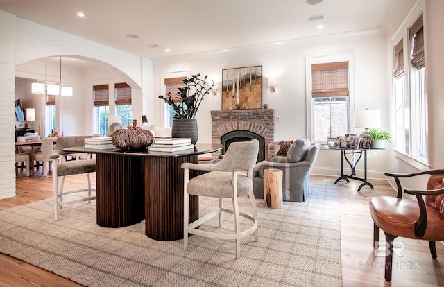 living room featuring light wood-type flooring and a fireplace