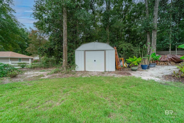 view of yard with a storage shed and an outdoor structure