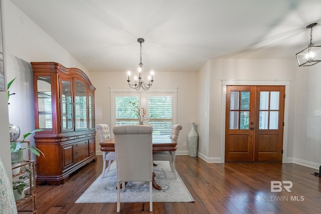 dining area with an inviting chandelier, french doors, dark wood-style flooring, and baseboards