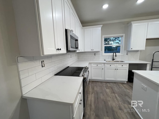 kitchen featuring range with electric cooktop, stainless steel microwave, a sink, crown molding, and backsplash