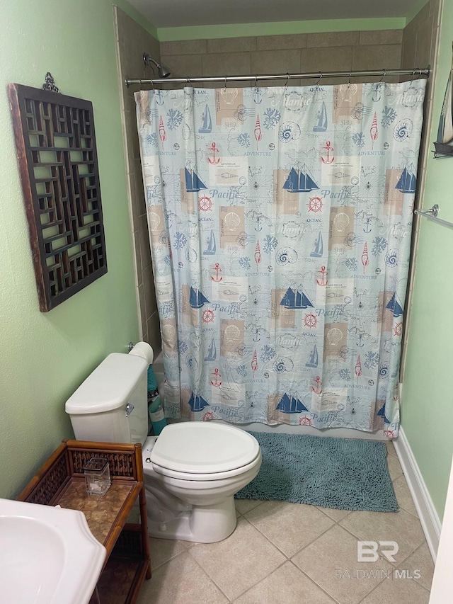 bathroom featuring tile flooring and toilet