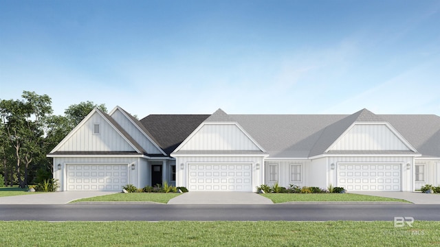 view of front of property with a garage and a front lawn