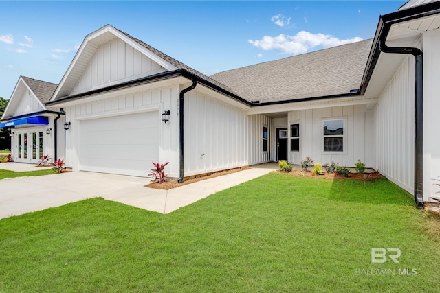 view of front of house with a front yard and a garage