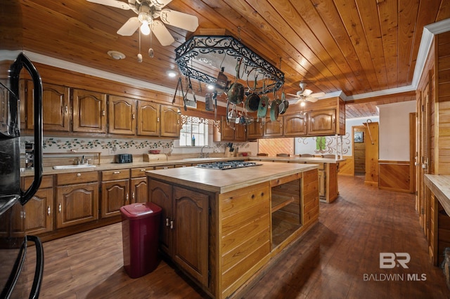 kitchen with ceiling fan, a kitchen island, dark hardwood / wood-style floors, and wood ceiling