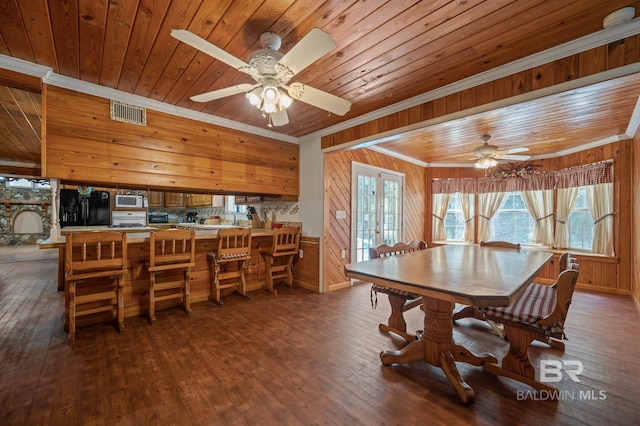 dining room featuring wood ceiling, ceiling fan, ornamental molding, dark hardwood / wood-style flooring, and french doors