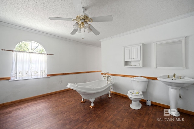 bathroom with ceiling fan, ornamental molding, wood-type flooring, and a textured ceiling