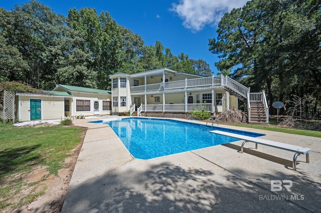 view of pool with an outbuilding, a patio area, and ceiling fan