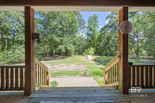 wooden terrace featuring a yard