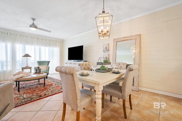 dining space featuring ornamental molding, ceiling fan with notable chandelier, and light tile patterned floors