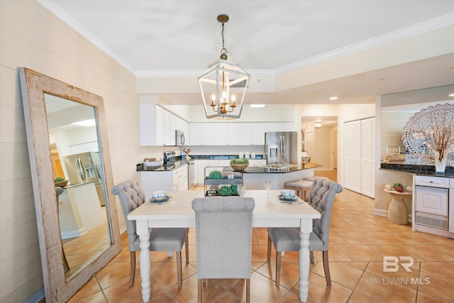 tiled dining space with an inviting chandelier and crown molding