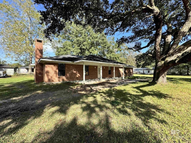 2316 Reneke Ave, Mobile, AL 36605 - view of side of property featuring a chimney, a yard, brick siding, and a porch