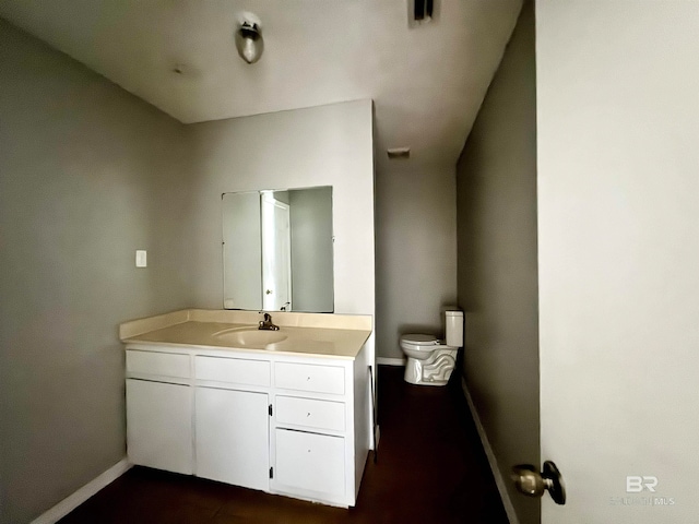 bathroom featuring toilet and vanity