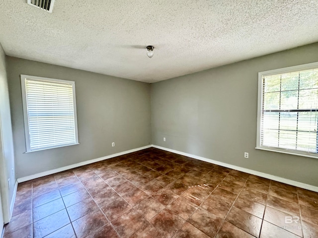 empty room with a textured ceiling